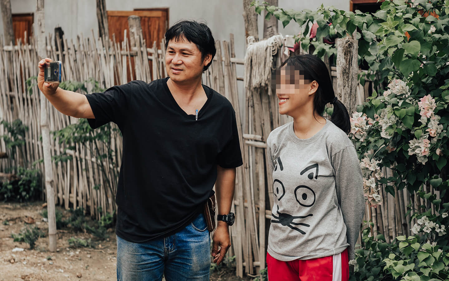 Subin, Destiny Rescue caseworker, grabs a selfie with a survivor during a visit to her village.