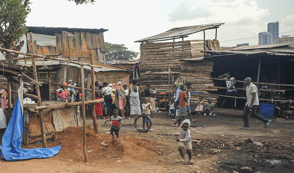 With skyscrapers looming in the background, a community in Uganda demonstrates the harsh realities of many of the country’s citizens
